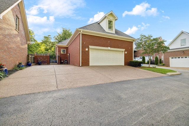 314 W 6th St Unit 7, Columbia, TN 38401 - view of home's exterior with a garage, concrete driveway, brick siding, and roof with shingles