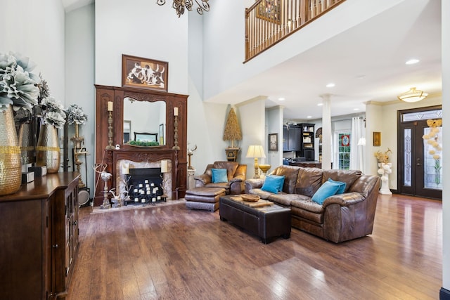 314 W 6th St Unit 7, Columbia, TN 38401 - living room featuring dark wood-style floors, decorative columns, a towering ceiling, a fireplace, and recessed lighting