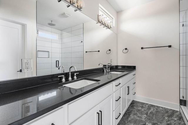 713B 32nd Ave N, Nashville, TN 37209 - bathroom featuring double vanity, a shower stall, baseboards, and marble look tile flooring