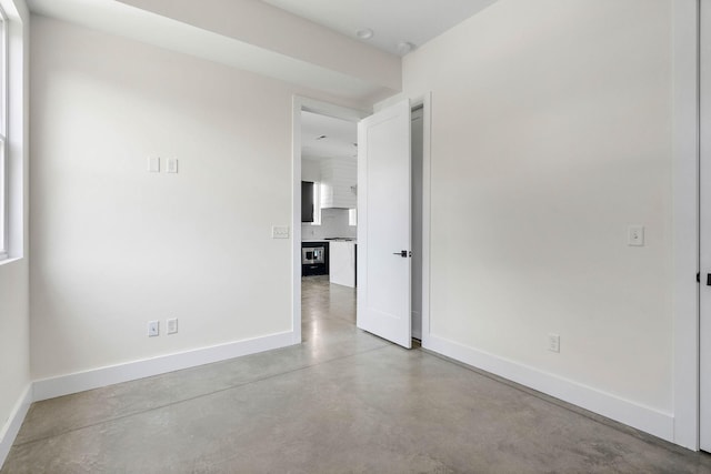 713B 32nd Ave N, Nashville, TN 37209 - unfurnished room featuring baseboards and concrete floors