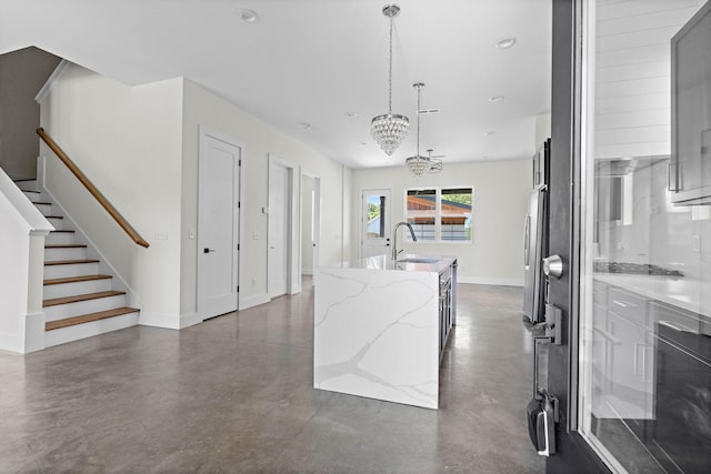 713B 32nd Ave N, Nashville, TN 37209 - kitchen featuring a sink, finished concrete floors, an island with sink, freestanding refrigerator, and recessed lighting