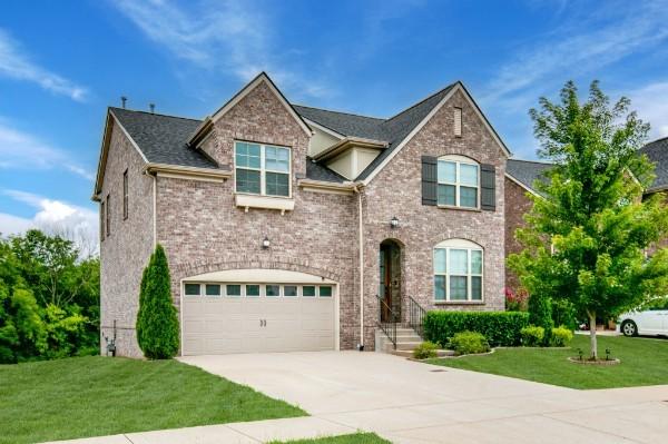 372 Old Stone Rd, Goodlettsville, TN 37072 - view of front facade featuring concrete driveway, an attached garage, a front yard, and brick siding