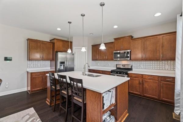 372 Old Stone Rd, Goodlettsville, TN 37072 - kitchen with stainless steel appliances, a sink, brown cabinets, and recessed lighting