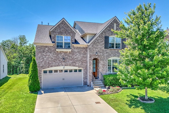 372 Old Stone Rd, Goodlettsville, TN 37072 - view of front facade featuring concrete driveway, a garage, a front lawn, brick siding, and a shingled roof