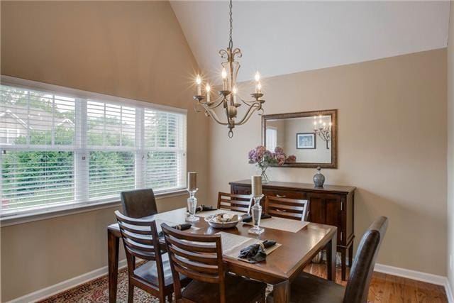 1602 Zurich Dr, Spring Hill, TN 37174 - dining room featuring a chandelier, baseboards, lofted ceiling, and wood finished floors