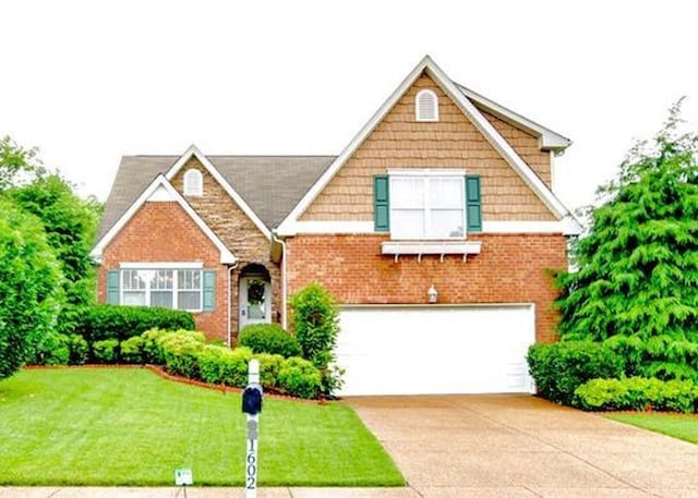 1602 Zurich Dr, Spring Hill, TN 37174 - view of front facade with an attached garage, driveway, a front lawn, and brick siding