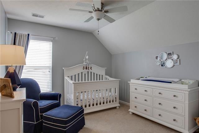 1602 Zurich Dr, Spring Hill, TN 37174 - bedroom with light colored carpet, vaulted ceiling, a nursery area, a ceiling fan, and baseboards