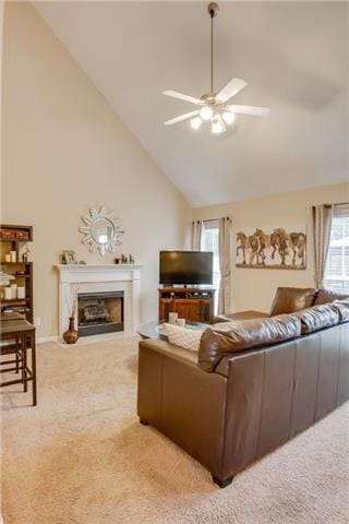 1602 Zurich Dr, Spring Hill, TN 37174 - carpeted living area with high vaulted ceiling, a ceiling fan, and a fireplace with raised hearth