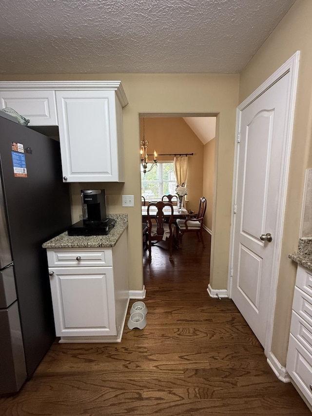 1602 Zurich Dr, Spring Hill, TN 37174 - corridor with a chandelier, dark wood-style floors, baseboards, and a textured ceiling