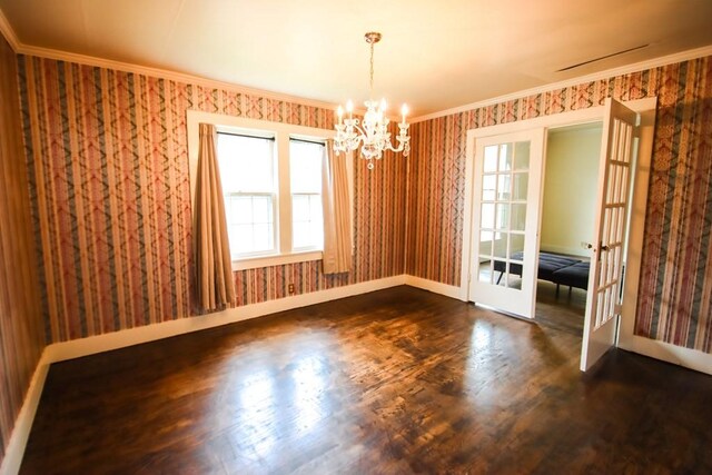 112 N Church St, Sparta, TN 38583 - empty room with wallpapered walls, a chandelier, french doors, dark wood-style floors, and ornamental molding