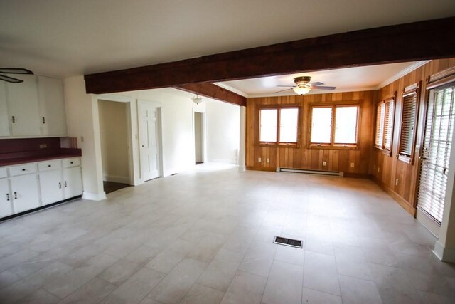 112 N Church St, Sparta, TN 38583 - unfurnished living room with ceiling fan, baseboard heating, beam ceiling, baseboards, and wood walls