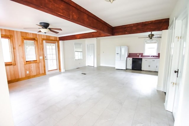 112 N Church St, Sparta, TN 38583 - unfurnished living room with ceiling fan, beam ceiling, a sink, baseboards, and wooden walls