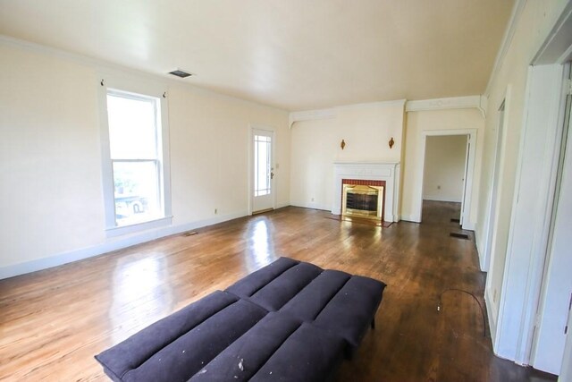 112 N Church St, Sparta, TN 38583 - unfurnished living room with wood finished floors, a fireplace, ornamental molding, and baseboards
