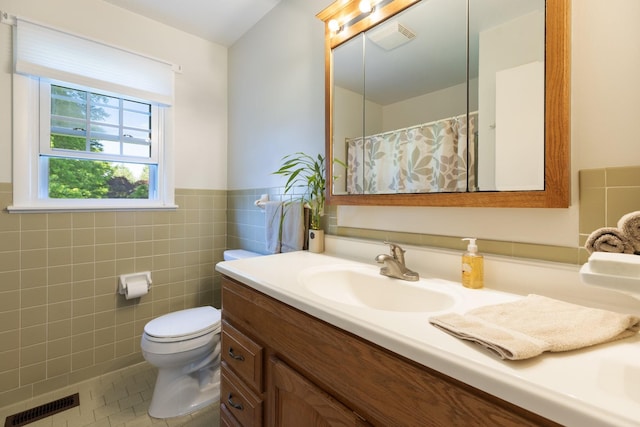 203 Hesta St, Spring Hill, TN 37174 - full bath with vanity, tile patterned floors, toilet, tile walls, and a wainscoted wall
