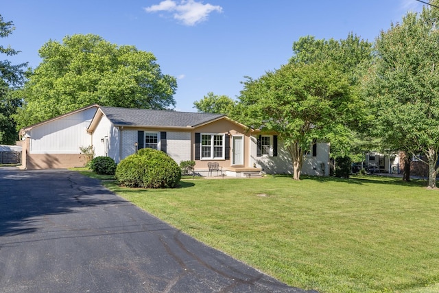 203 Hesta St, Spring Hill, TN 37174 - ranch-style house featuring a front yard, brick siding, and asphalt driveway
