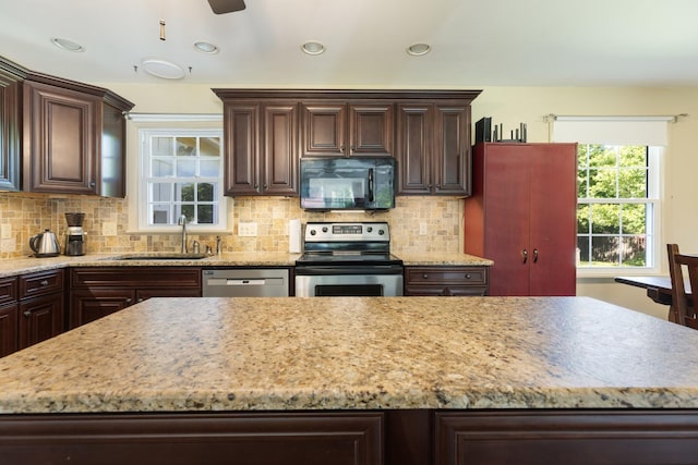 203 Hesta St, Spring Hill, TN 37174 - kitchen with stainless steel appliances, a sink, dark brown cabinets, backsplash, and recessed lighting