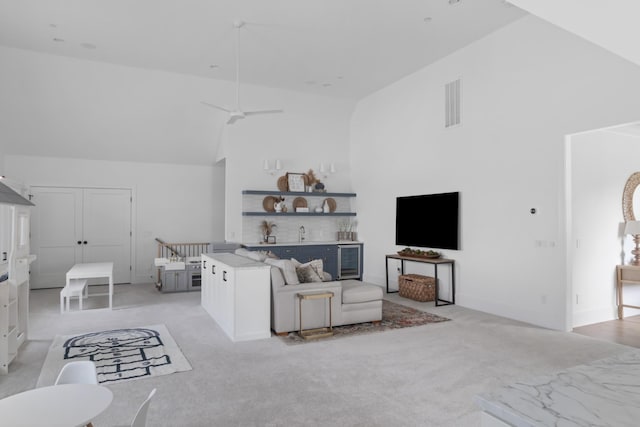 1936 Silver Fox Rd, Thompsons Station, TN 37179 - living area with high vaulted ceiling, light carpet, beverage cooler, and ceiling fan