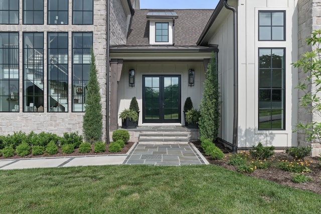 1936 Silver Fox Rd, Thompsons Station, TN 37179 - property entrance featuring french doors, roof with shingles, stone siding, a yard, and a standing seam roof