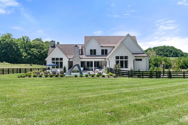 1936 Silver Fox Rd, Thompsons Station, TN 37179 - rear view of property featuring a chimney, board and batten siding, and a patio