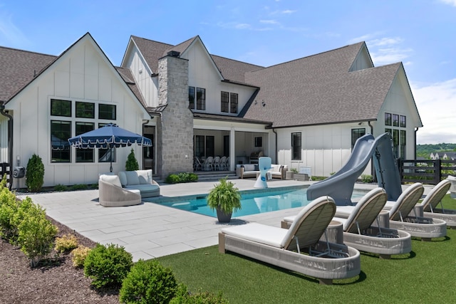 1936 Silver Fox Rd, Thompsons Station, TN 37179 - back of house featuring roof with shingles, an outdoor living space, a patio area, and an outdoor pool
