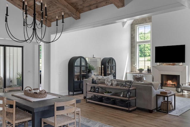 1936 Silver Fox Rd, Thompsons Station, TN 37179 - dining room with wood ceiling with exposed beams, wood finished floors, a lit fireplace, a chandelier, and a towering ceiling