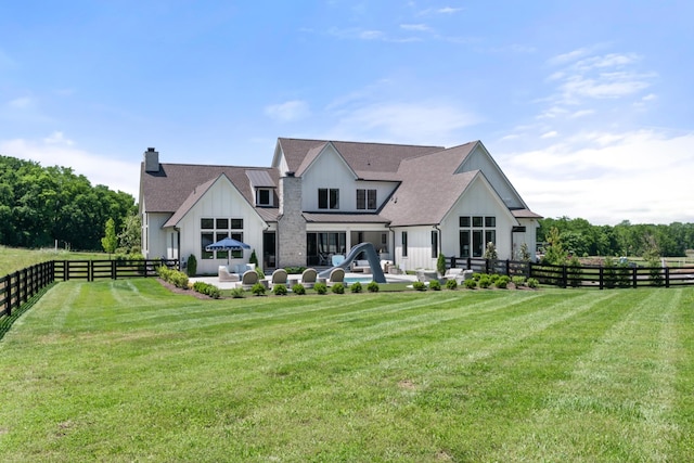 1936 Silver Fox Rd, Thompsons Station, TN 37179 - back of property featuring a patio, a chimney, and a shingled roof