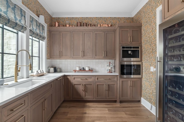 1936 Silver Fox Rd, Thompsons Station, TN 37179 - kitchen featuring a sink, wine cooler, wallpapered walls, light wood finished floors, and light countertops