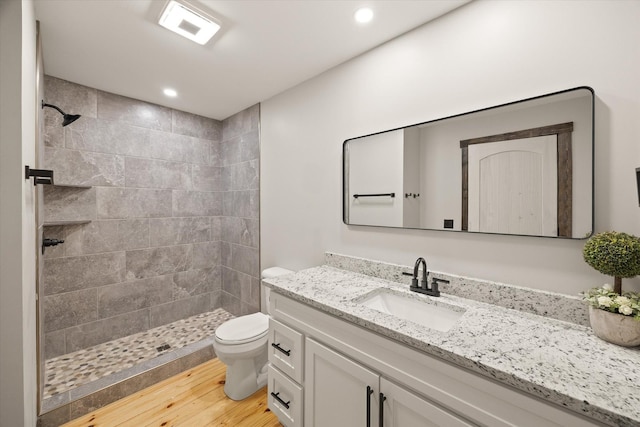 4221 New Hope Rd, Celina, TN 38551 - full bathroom featuring vanity, tiled shower, toilet, wood finished floors, and recessed lighting