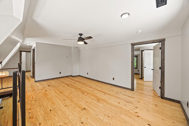 4221 New Hope Rd, Celina, TN 38551 - empty room with ceiling fan, light wood finished floors, baseboards, and vaulted ceiling