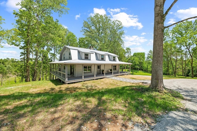 4221 New Hope Rd, Celina, TN 38551 - view of front of house featuring metal roof, a porch, a chimney, curved driveway, and a gambrel roof
