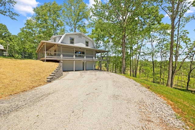 4221 New Hope Rd, Celina, TN 38551 - colonial inspired home featuring driveway, a gambrel roof, and stairs