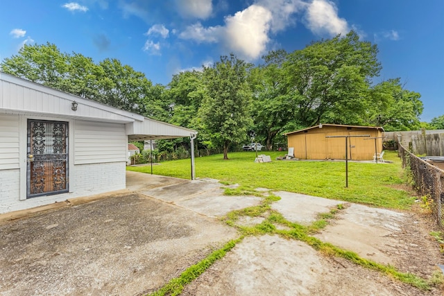 109 Garwood Dr, Nashville, TN 37210 - view of yard with driveway, a carport, and an outbuilding