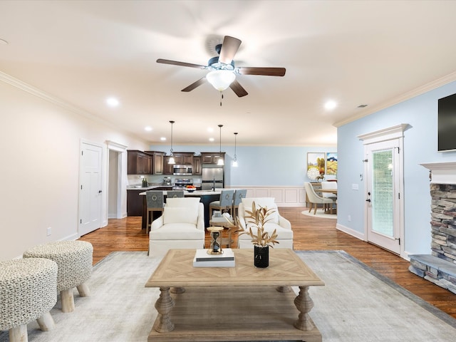 1116 Rivercrest Dr, Murfreesboro, TN 37129 - living room featuring light wood-style floors, crown molding, a ceiling fan, recessed lighting, and a stone fireplace