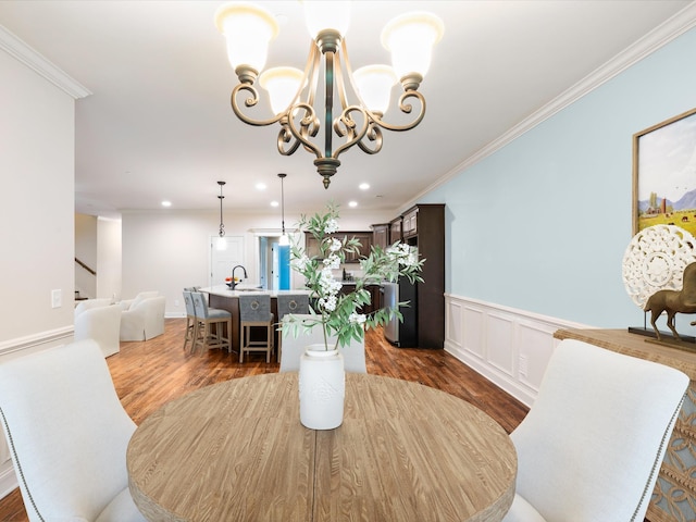 1116 Rivercrest Dr, Murfreesboro, TN 37129 - dining area with wood finished floors, a chandelier, crown molding, wainscoting, and recessed lighting