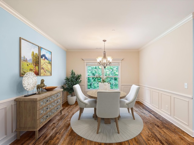 1116 Rivercrest Dr, Murfreesboro, TN 37129 - dining room with a chandelier, dark wood-style flooring, a wainscoted wall, crown molding, and a decorative wall