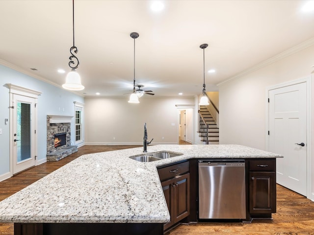 1116 Rivercrest Dr, Murfreesboro, TN 37129 - kitchen with stainless steel dishwasher, a sink, ornamental molding, dark brown cabinetry, and a fireplace