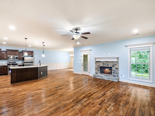 1116 Rivercrest Dr, Murfreesboro, TN 37129 - kitchen featuring stainless steel appliances, open floor plan, dark brown cabinetry, a sink, and light countertops