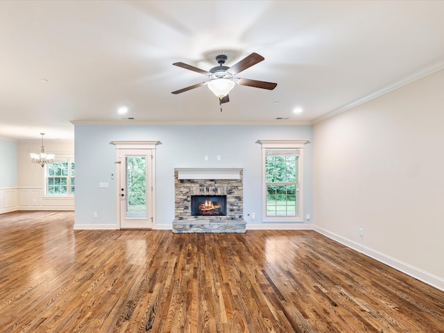 1116 Rivercrest Dr, Murfreesboro, TN 37129 - unfurnished living room featuring a chandelier, a stone fireplace, ceiling fan, wood finished floors, and crown molding