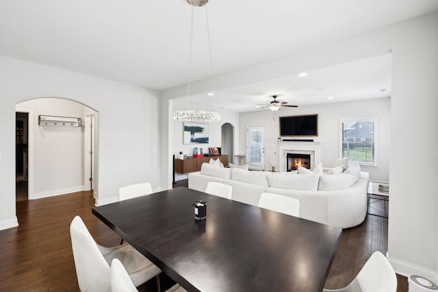4337 Peacemill Ln, Murfreesboro, TN 37128 - dining space featuring arched walkways, ceiling fan, dark wood finished floors, a fireplace, and recessed lighting