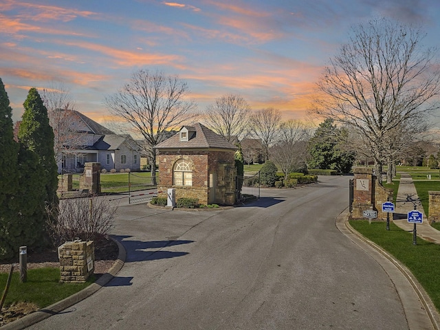 4337 Peacemill Ln, Murfreesboro, TN 37128 - view of asphalt street with curbs, a gated entry, a gate, and traffic signs