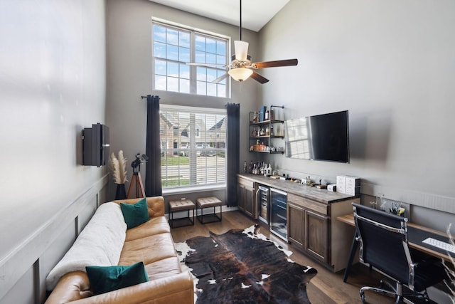 4337 Peacemill Ln, Murfreesboro, TN 37128 - living area with a bar, beverage cooler, wood finished floors, ceiling fan, and a high ceiling