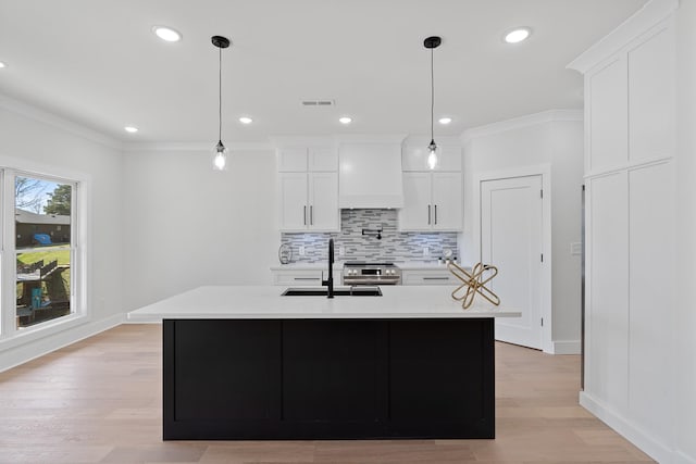 199 Beach Rd N, Killen, AL 35645 - kitchen with decorative backsplash, light countertops, white cabinetry, a sink, and recessed lighting