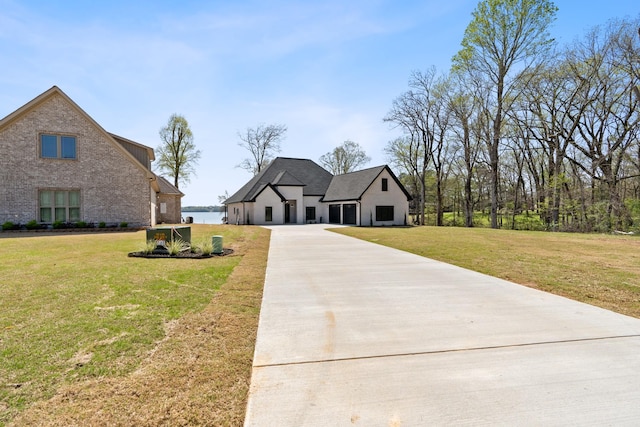199 Beach Rd N, Killen, AL 35645 - view of front of house featuring driveway, a front yard, and brick siding