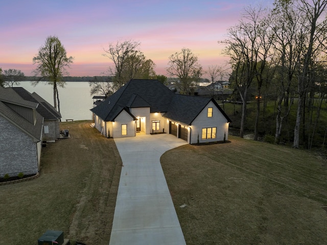 199 Beach Rd N, Killen, AL 35645 - view of front of home with concrete driveway, roof with shingles, a garage, a water view, and a front yard