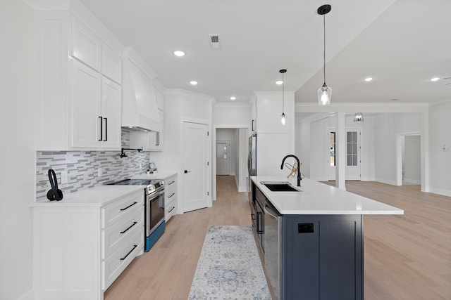199 Beach Rd N, Killen, AL 35645 - kitchen featuring stainless steel range with electric stovetop, a sink, light wood-style flooring, custom exhaust hood, and light countertops