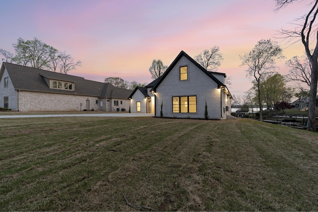 199 Beach Rd N, Killen, AL 35645 - back of property at dusk with a lawn and brick siding