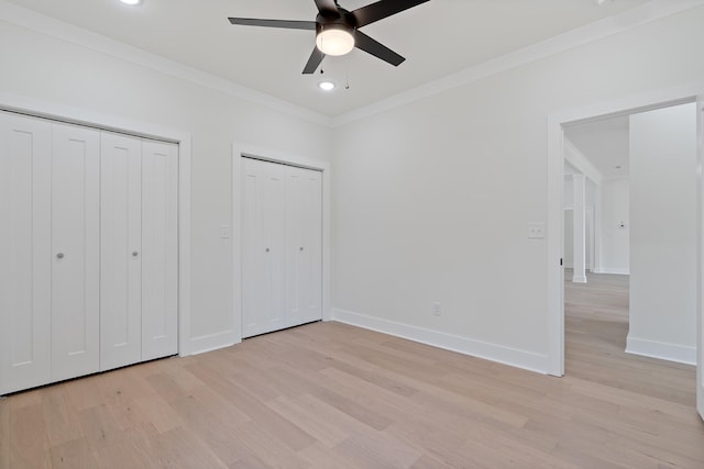 199 Beach Rd N, Killen, AL 35645 - unfurnished bedroom featuring two closets, light wood-style floors, crown molding, recessed lighting, and baseboards