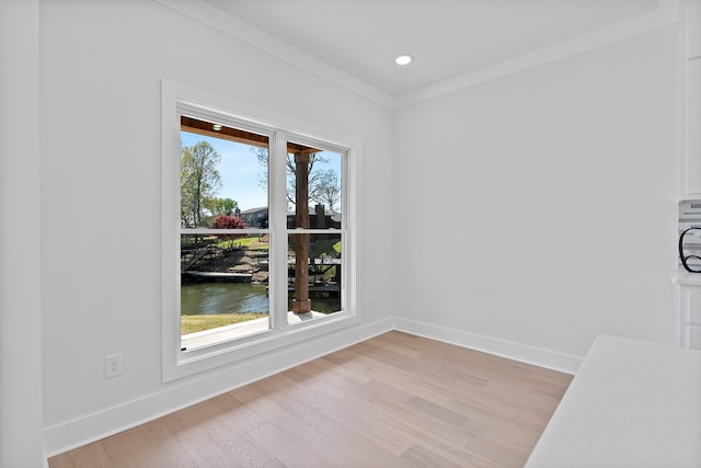 199 Beach Rd N, Killen, AL 35645 - unfurnished dining area with light wood-style flooring, a water view, baseboards, recessed lighting, and ornamental molding