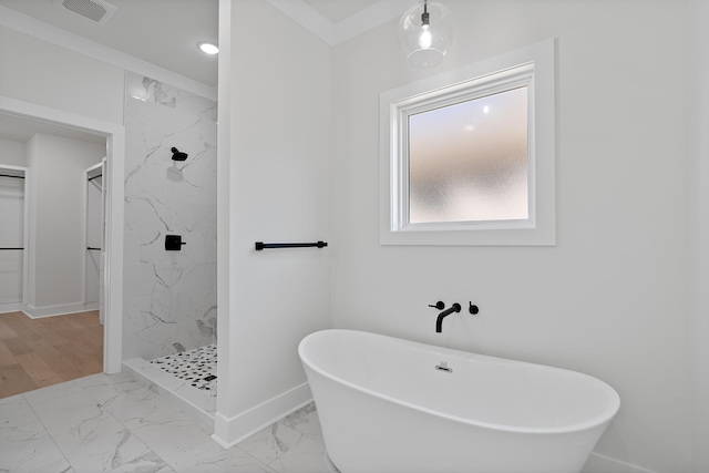 199 Beach Rd N, Killen, AL 35645 - bathroom with marble look tiles, a marble finish shower, a soaking tub, baseboards, and a walk in closet