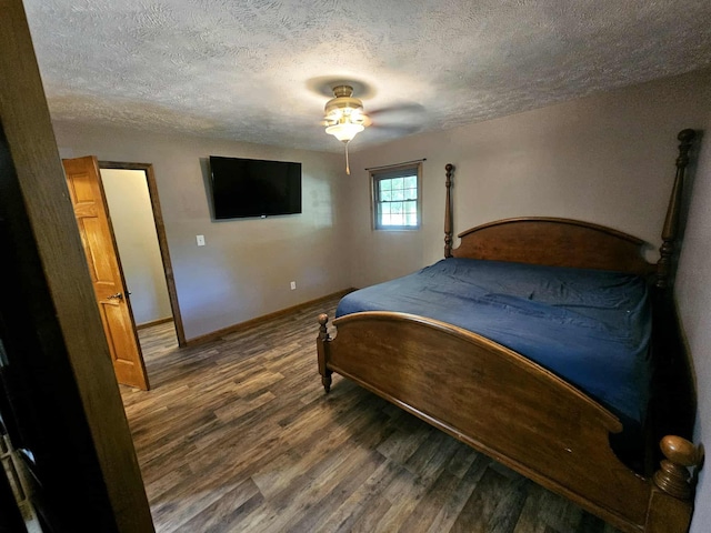 102 Hazelnut Ave, Camden, TN 38320 - bedroom with wood finished floors, a textured ceiling, baseboards, and ceiling fan